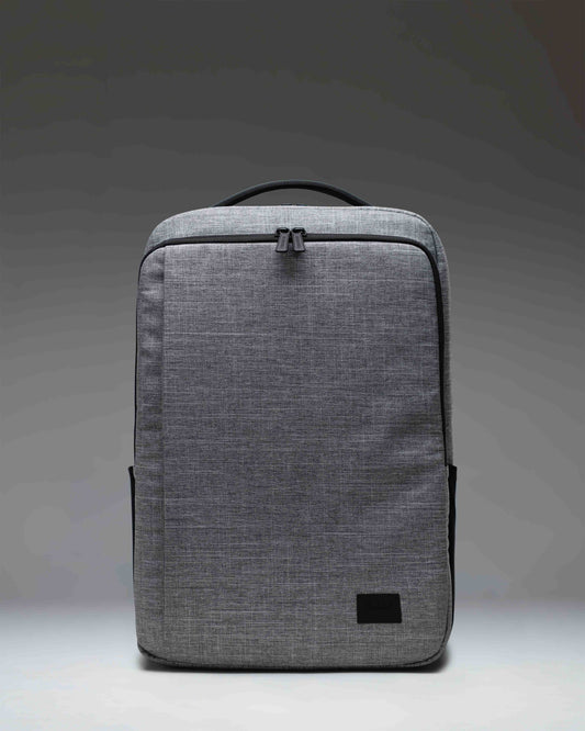 Herschel Supply Co. Kaslo Backpack Tech in Raven Crosshatch, showing a detailed view of the front pockets and textured grey fabric.