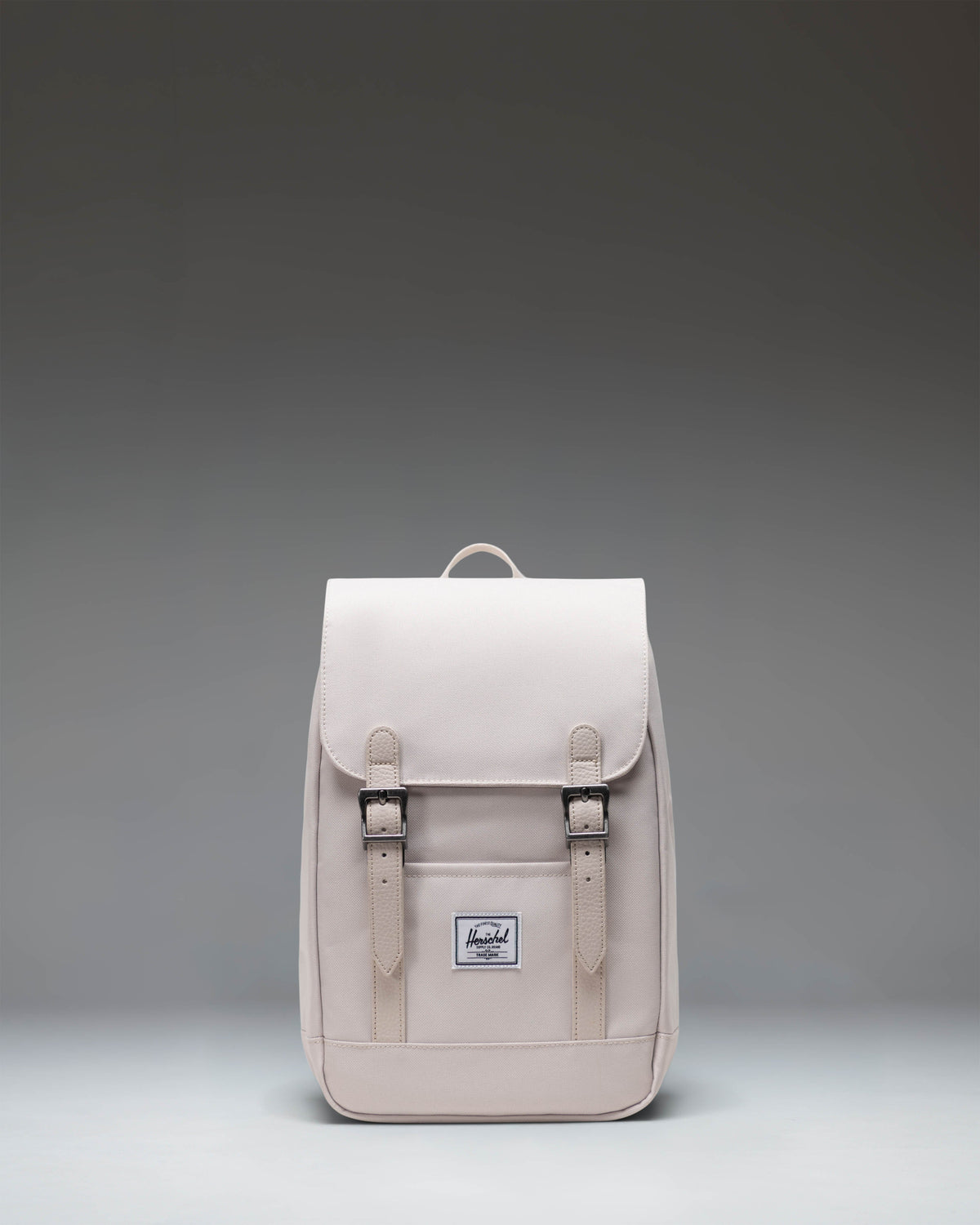 Herschel Retreat Mini Backpack in Moonbeam colorway, featuring a front storage sleeve and magnet fastened straps.