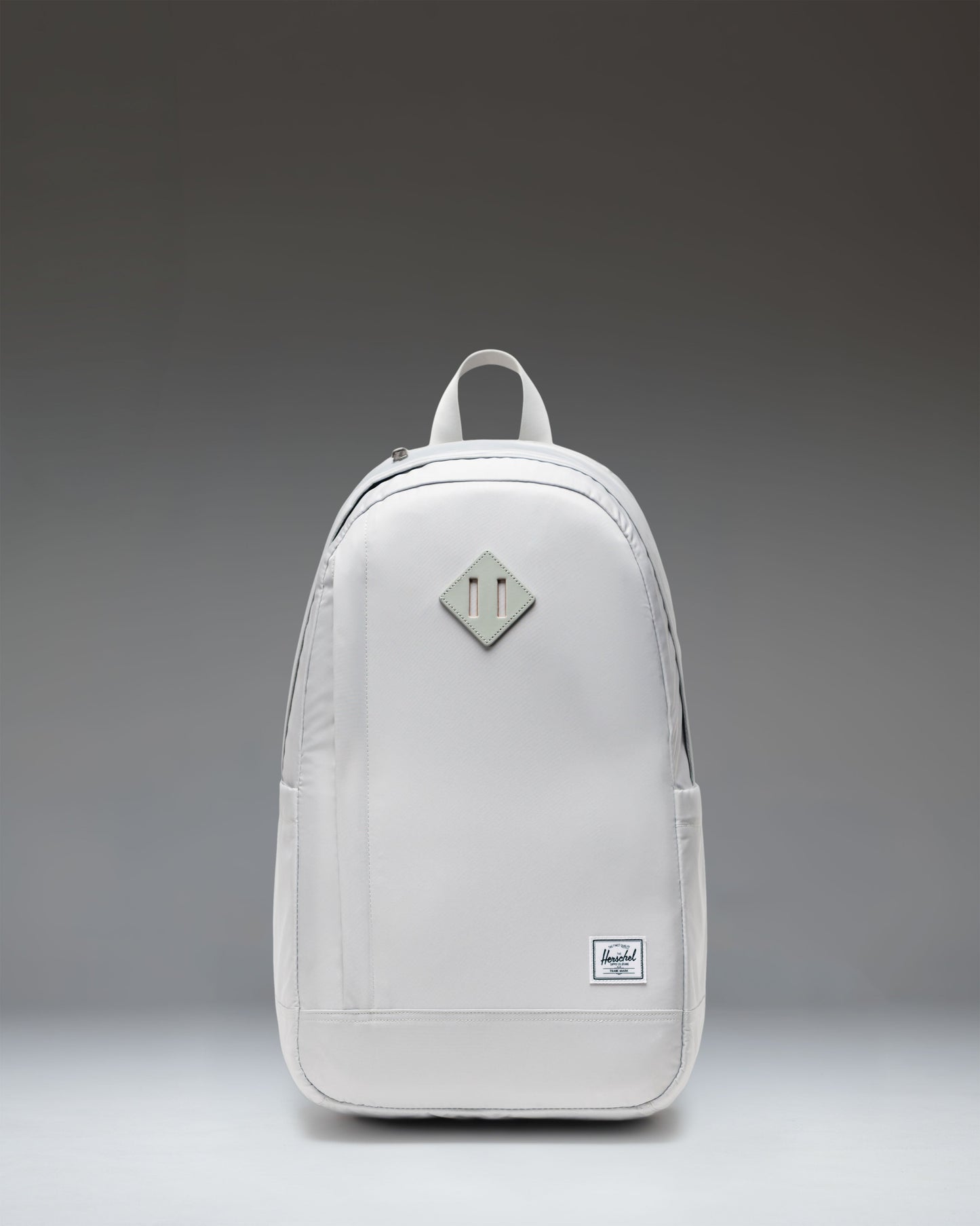 Herschel Supply Co. Seymour Backpack in Metal. Front view of the grey backpack with a front zipper pocket and classic Herschel logo.