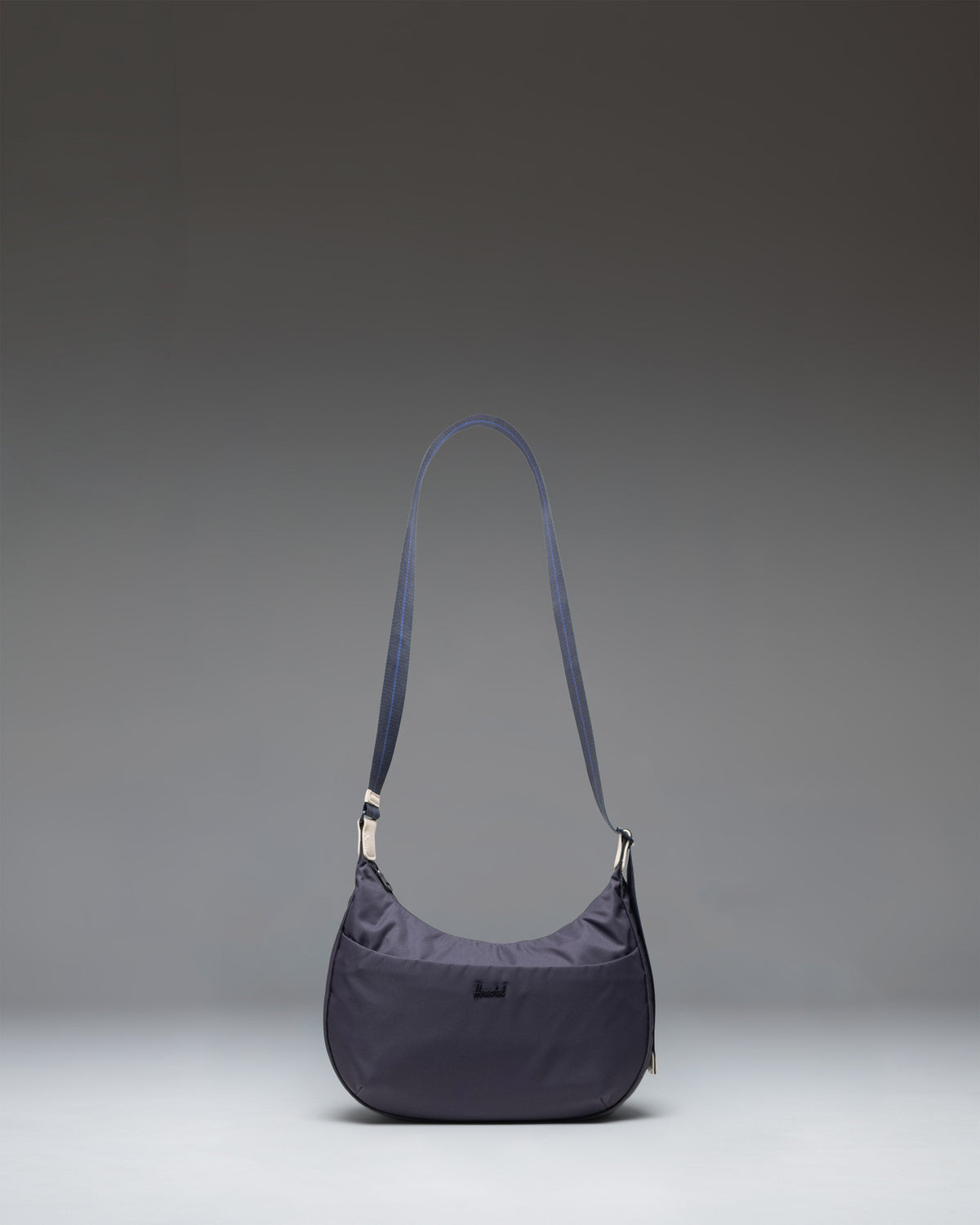 Herschel Supply Co. Yara Shoulder Bag in black showing the main compartment, zippered front pocket, and adjustable webbing strap.