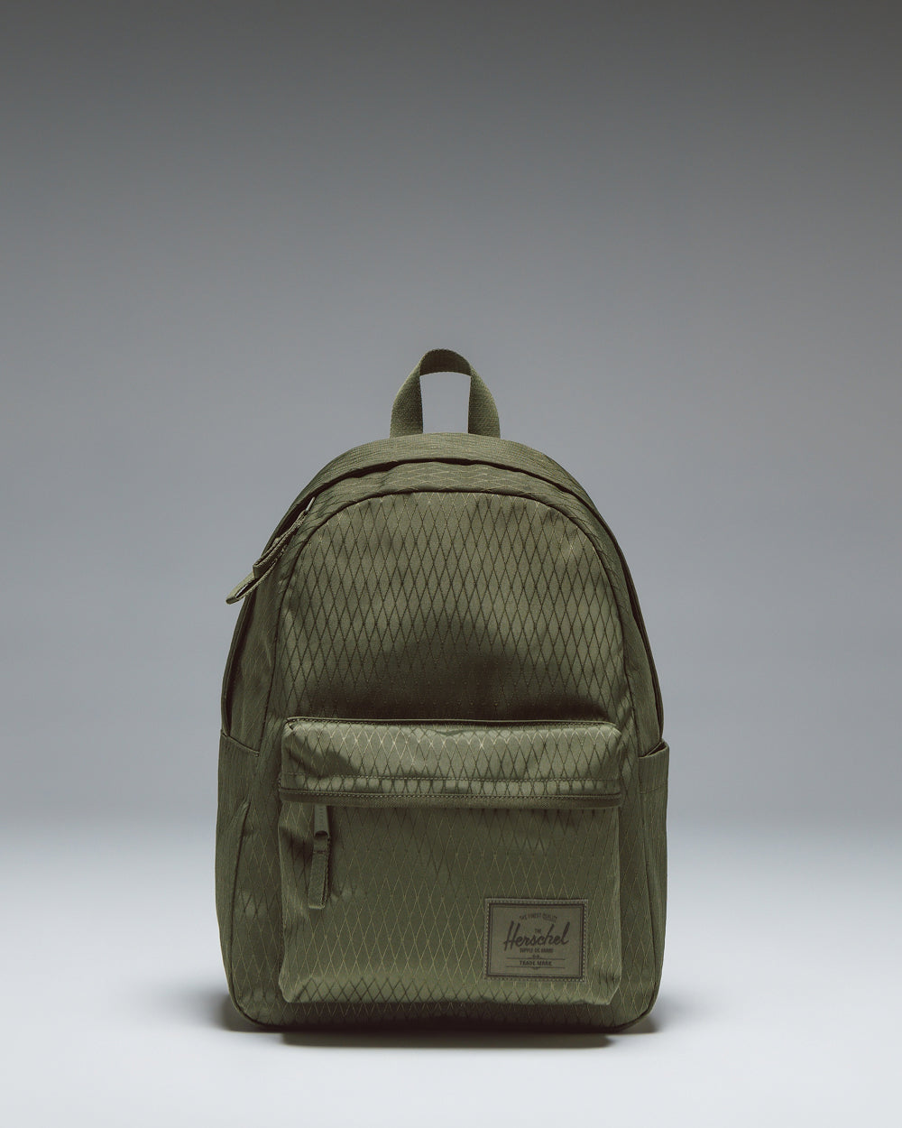 Herschel Classic Backpack in Ivy Green Diamond, featuring a clean, minimalist design with a front storage pocket and classic woven label.