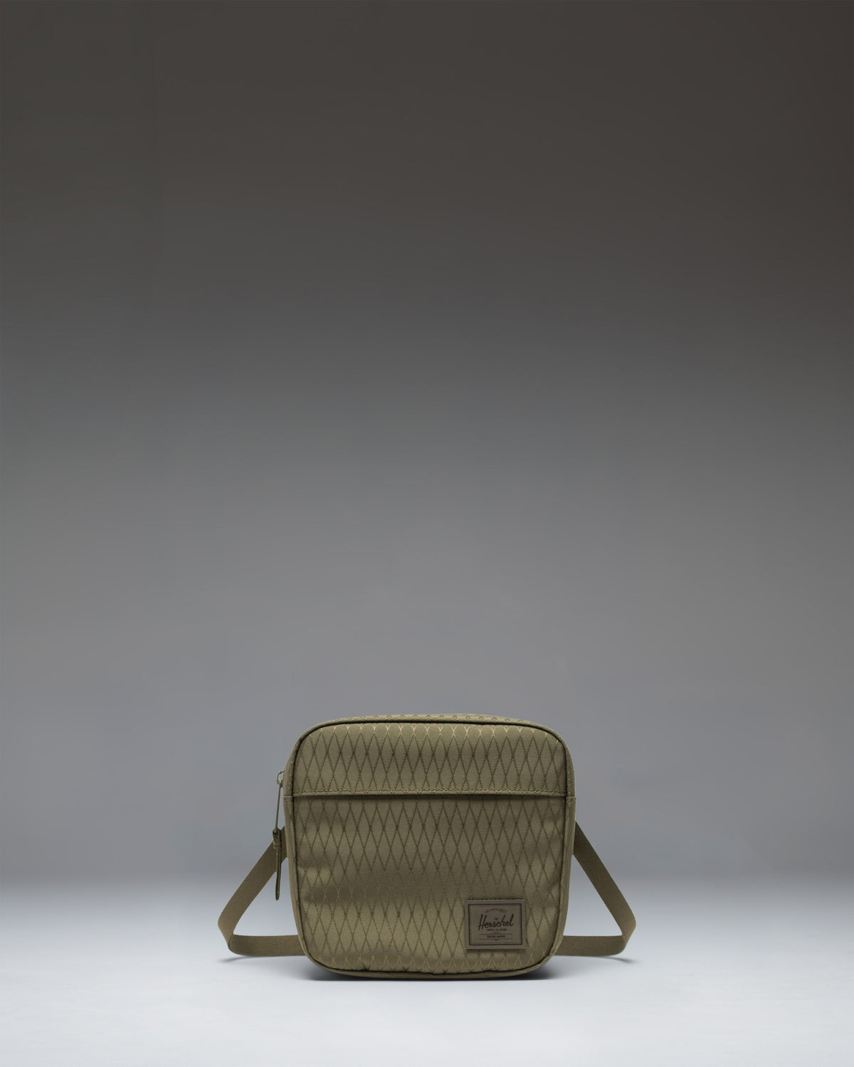 Herschel Classic Crossbody bag in Ivy Green Diamond colorway, featuring a clean rectangular design with a front zippered pocket and shoulder strap.