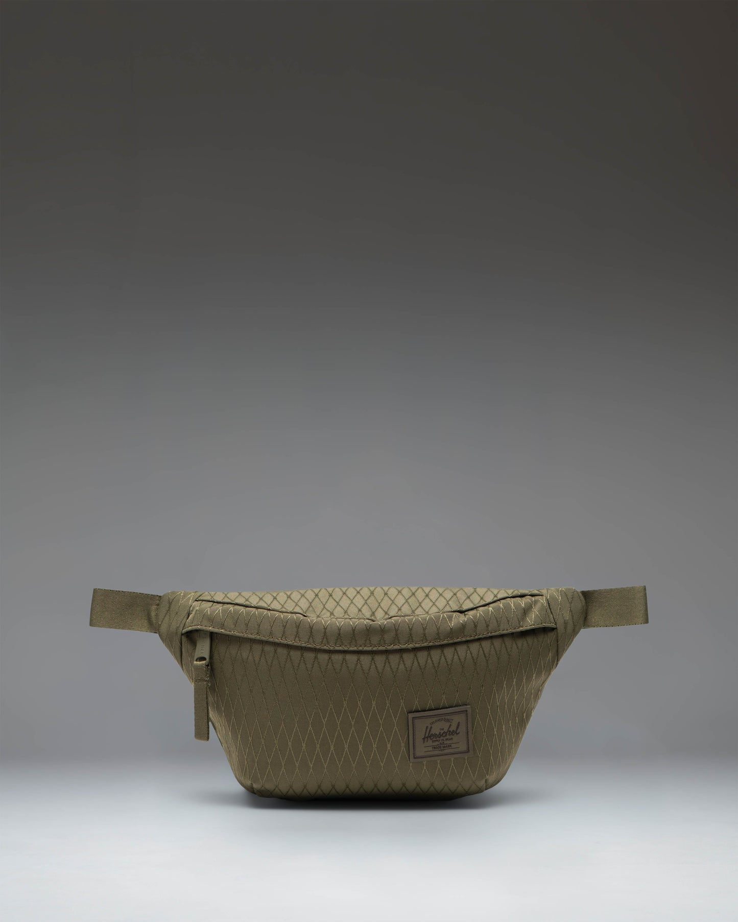 Herschel Supply Co. Classic Hip Pack in Ivy Green Diamond, showing the clean design and adjustable strap of the compact waist bag.