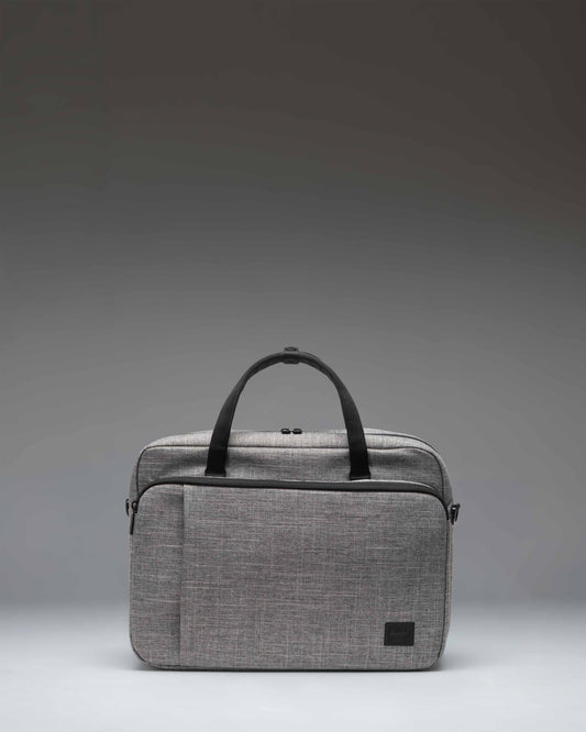 Herschel Supply Co. Gibson Messenger Tech bag in Raven Crosshatch grey, showing a front view with dual top handles and a zippered pocket.