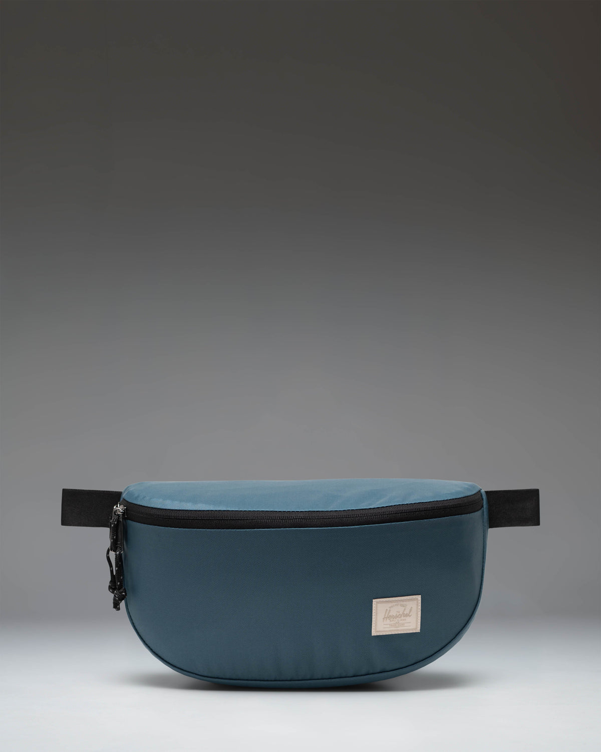 Herschel Supply Co. Kaine Hip Pack in Mediterranea blue, showing a slouchy silhouette with an adjustable strap and zippered closure.
