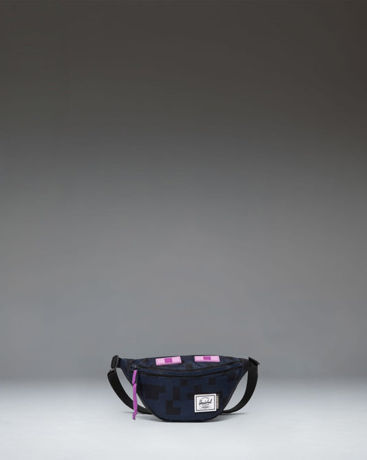 Minecraft Herschel Heritage Hip Pack Little Herschel in Enderman, featuring a black design with purple Minecraft pixel accents.