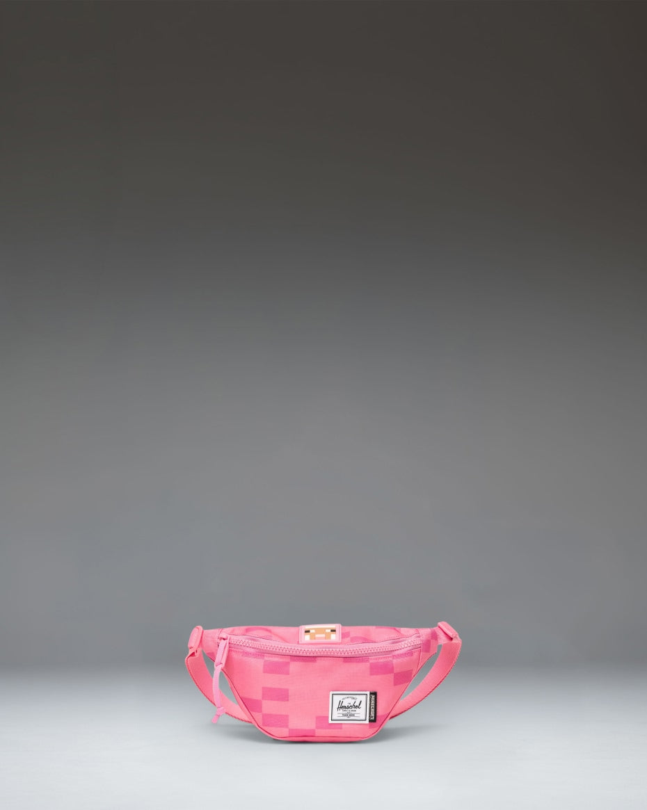 Pink Herschel Supply Co. x Minecraft Heritage Hip Pack with a pixelated Pink Sheep pattern and classic woven label.