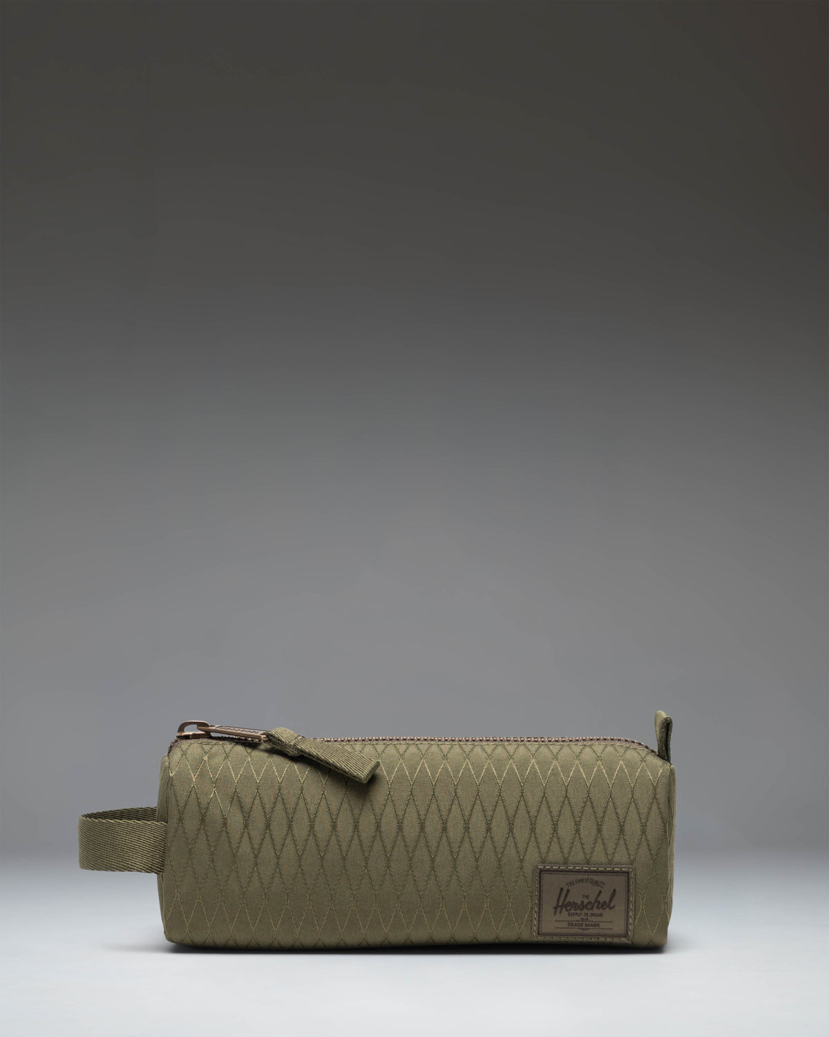 Herschel Supply Co. Settlement Pencil Case in Ivy Green Diamond, featuring a classic zippered design for carrying pens, pencils, and stationery.