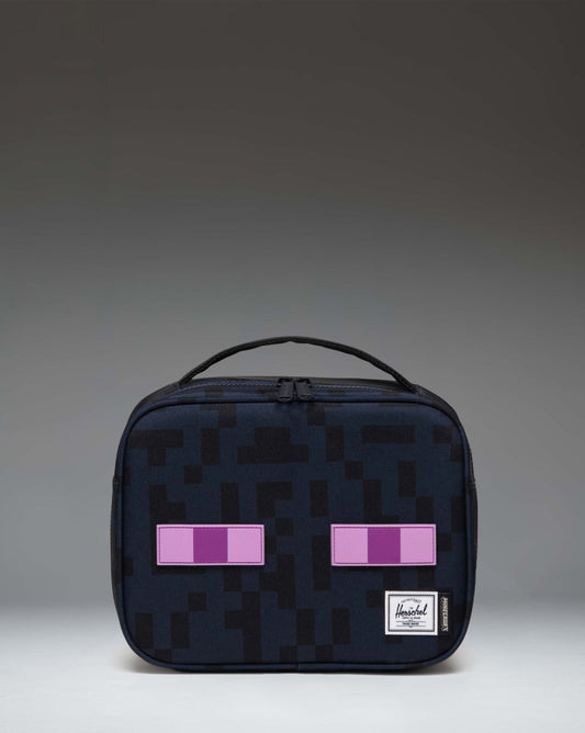 Herschel Supply Co. Minecraft Pop Quiz Lunch Box in black Enderman design, featuring a pixelated eye print and insulated main compartment.