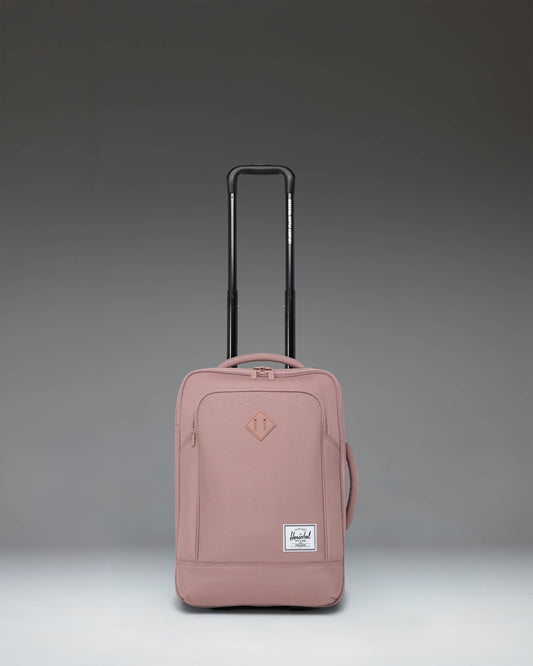 Herschel Supply Co Heritage Softshell Large CarryOn Luggage in Ash Rose pink, showing the front view with wheels and handle.