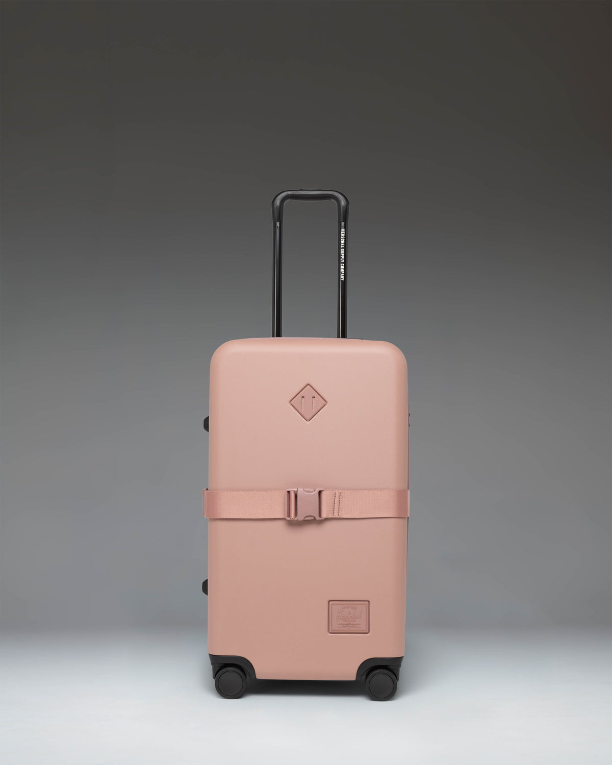 Herschel Heritage Hardshell Medium Luggage Exp in Ash Rose color, showing the front view of the hard-shell rolling suitcase.