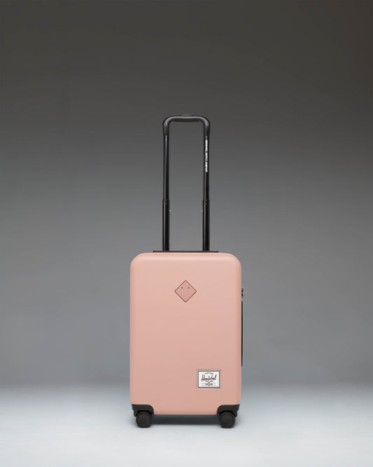 Herschel Heritage Hardshell Large CarryOn Luggage in Ash Rose pink.