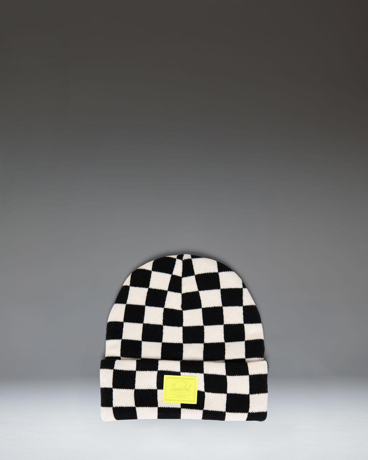 Herschel Supply Co Elmer Kids Graphic Beanie in a black and white checkerboard pattern.