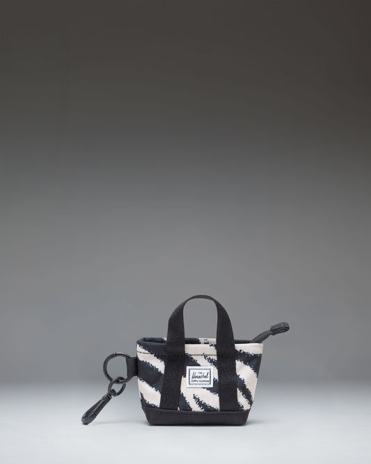 Herschel Supply Co. Herschel Heritage Tote Bag Charm in a striking black and white Zebra print design, featuring a convenient clip attachment.