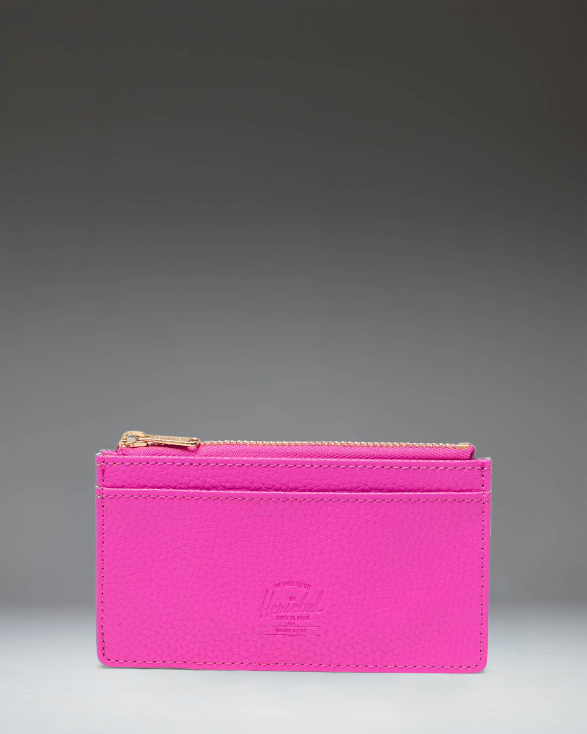 Herschel Supply Co. Oscar Large Cardholder in Rose Violet vegan leather, showing the front slots and classic woven label.