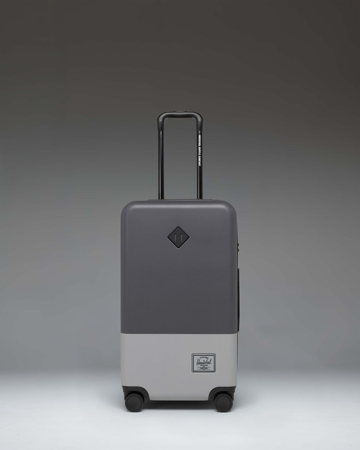 Herschel Heritage Hardshell Medium Luggage in Blocked Gray, showcasing a durable textured hard shell exterior with a classic design.
