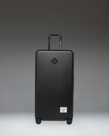 Front view of the Herschel Heritage Hardshell Large Luggage in black, showing its durable, textured exterior design.