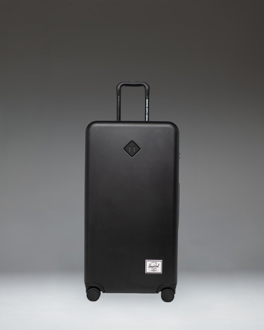 Front view of the Herschel Heritage Hardshell Large Luggage in black, showing its durable, textured exterior design.