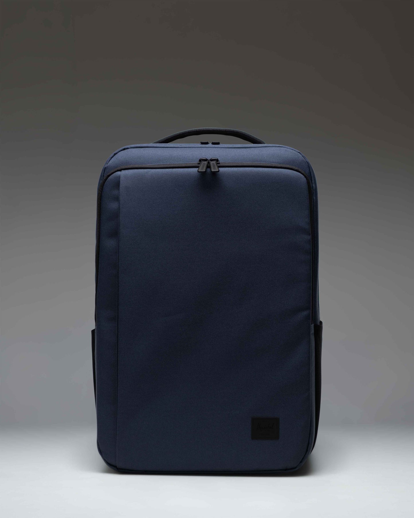 Herschel Supply Co. Kaslo Backpack Tech in Mood Indigo, showing the front view with zipper compartments and adjustable shoulder straps.