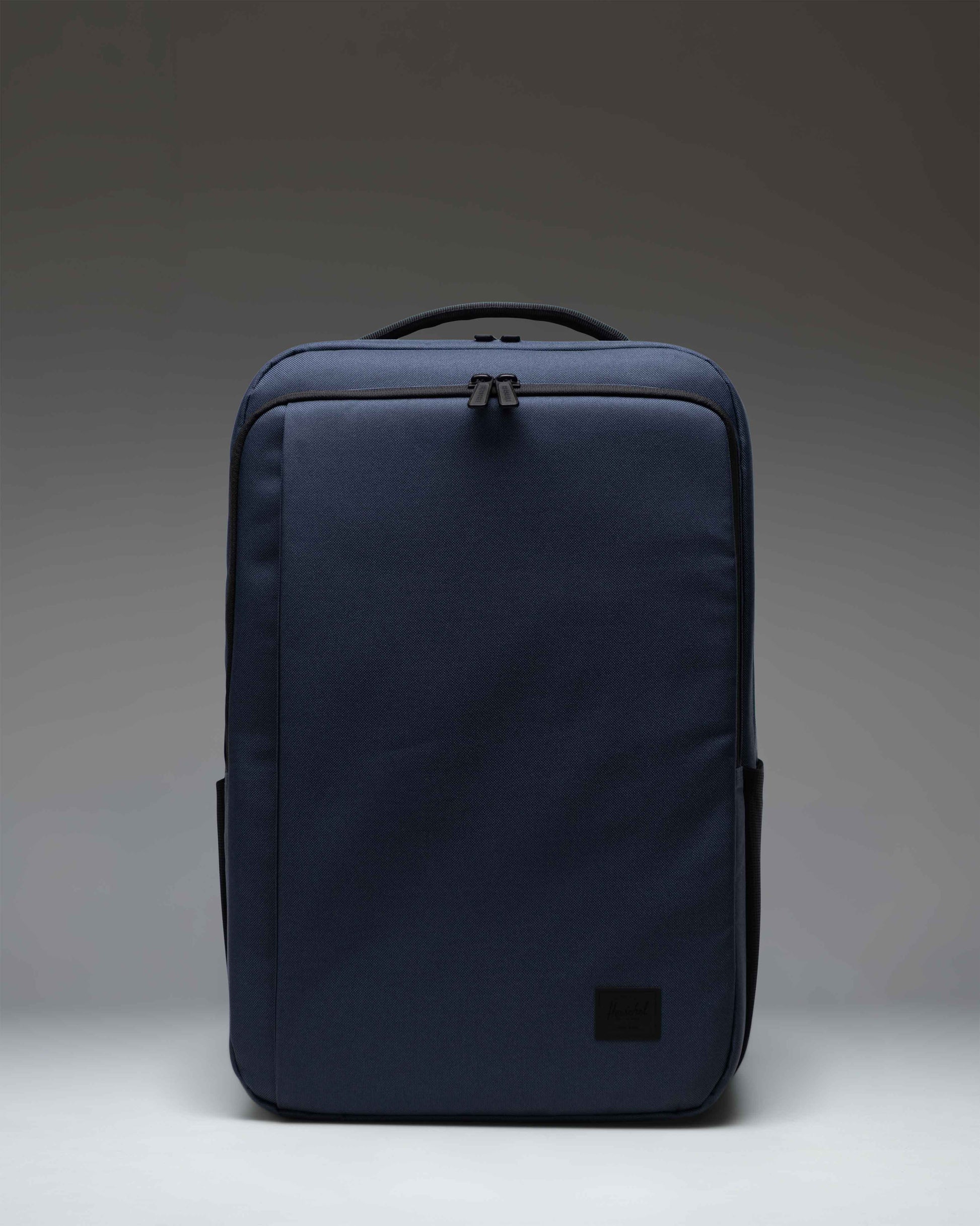 Herschel Supply Co. Kaslo Backpack Tech in Mood Indigo, showing the front view with zipper compartments and adjustable shoulder straps.