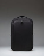 Black Herschel Supply Co. Kaslo Daypack Tech backpack viewed from the front, showcasing its clean design, dual top handles, and zippered pockets.