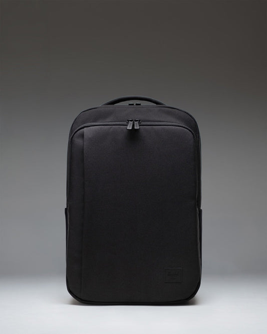 Black Herschel Supply Co. Kaslo Daypack Tech backpack viewed from the front, showcasing its clean design, dual top handles, and zippered pockets.