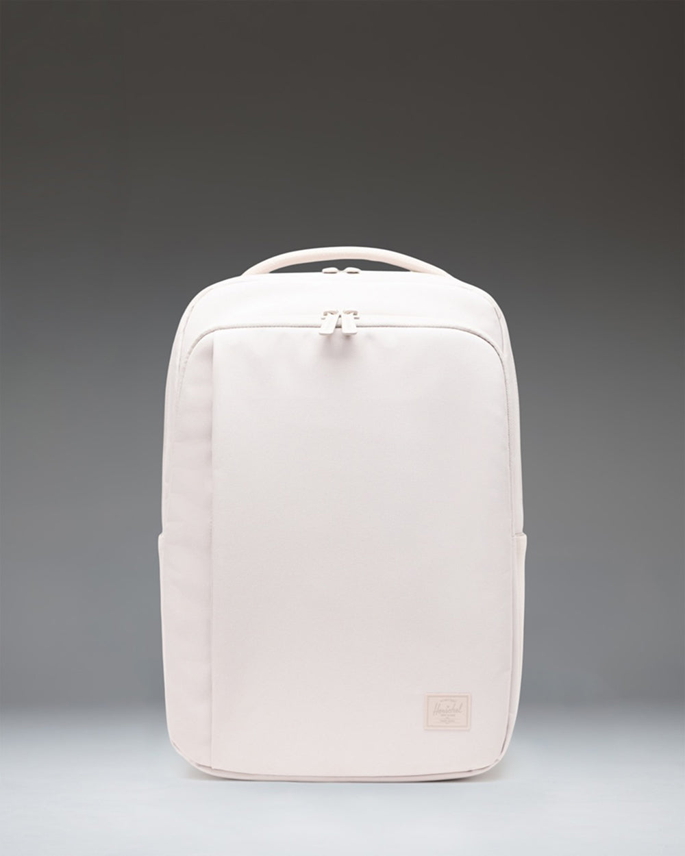 Herschel Supply Co. Kaslo Daypack Tech in Moonbeam Tonal, showing the front view of the minimalist, light grey tech backpack.