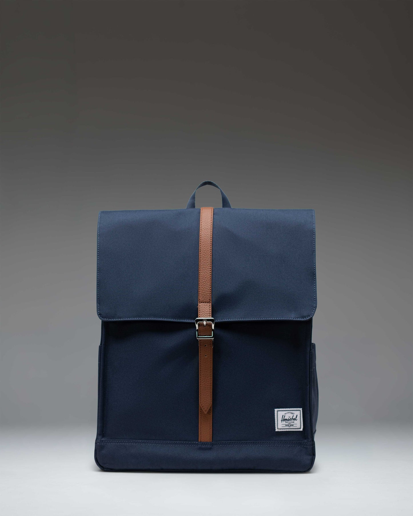 Herschel Supply Co. City Backpack in navy blue, showcasing its clean design, single strap closure, and front storage pocket.