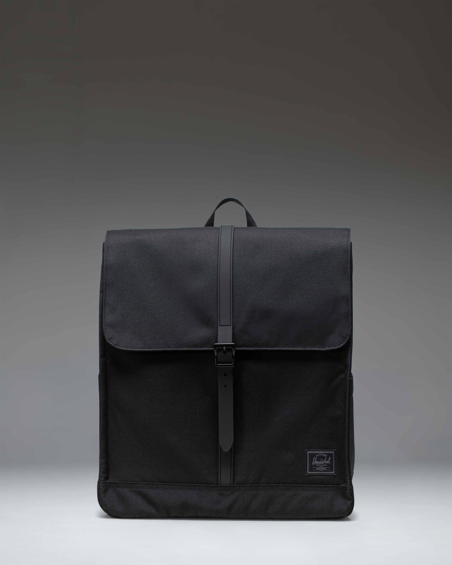 Black Herschel Supply Co. City Backpack shown from the front, highlighting its minimalist design, single strap closure, and clean aesthetic.
