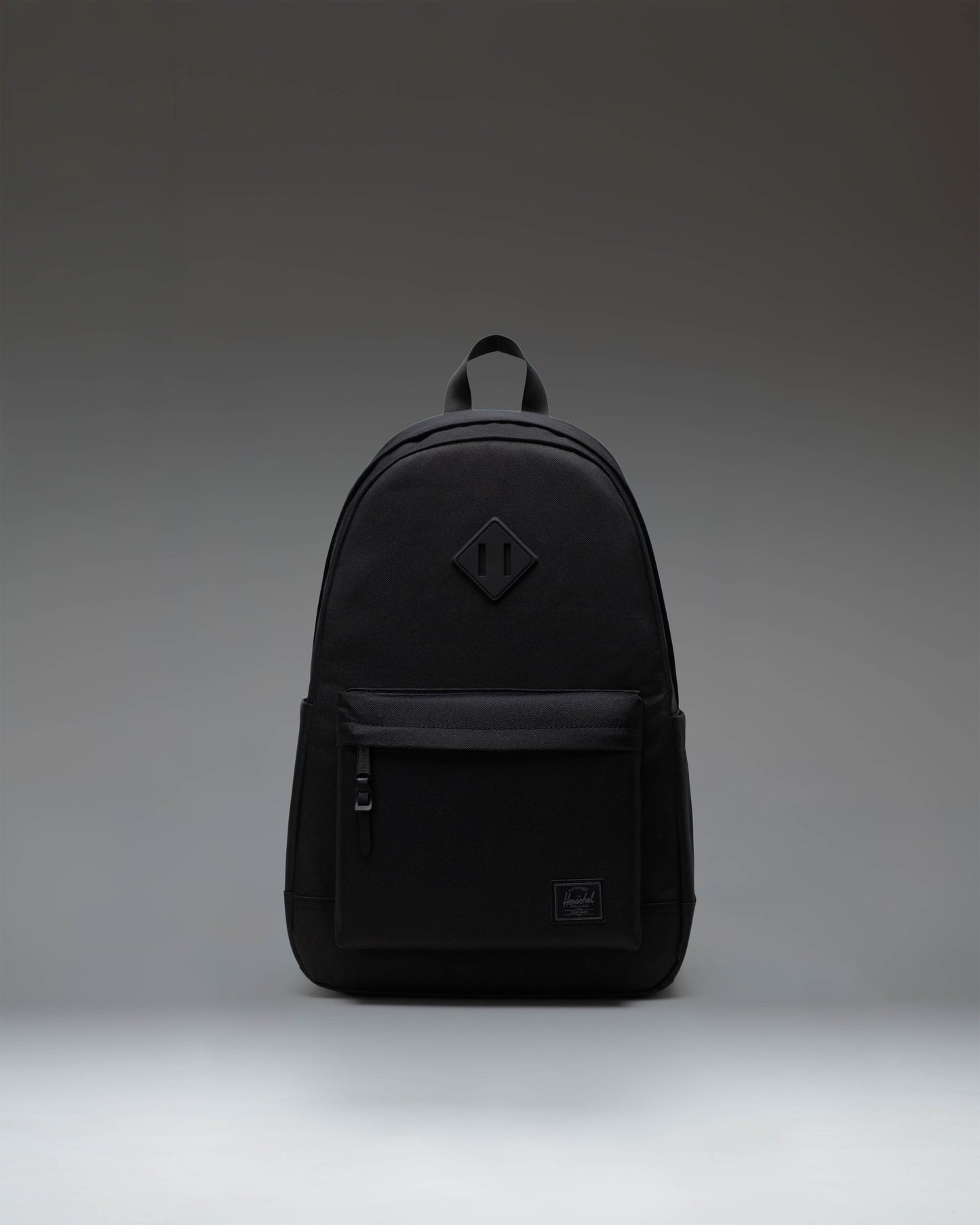 Herschel Supply Co. Heritage Backpack in Black Tonal, featuring a classic design with a front pocket and diamond accent.