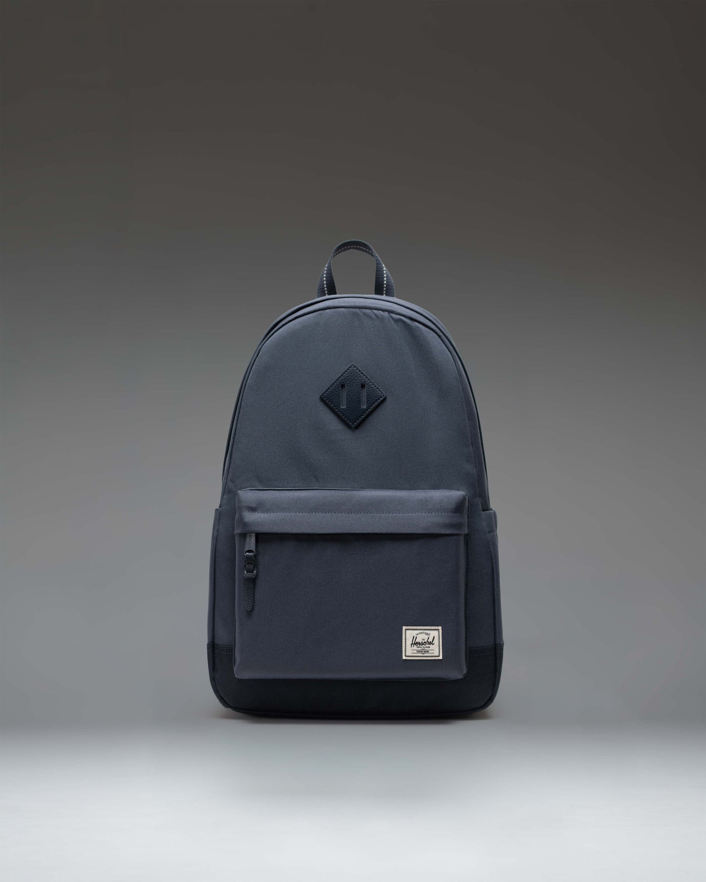 Herschel Heritage Backpack in Ombre Blue/After Midnight colorway featuring a front zippered pocket and classic diamond accent.
