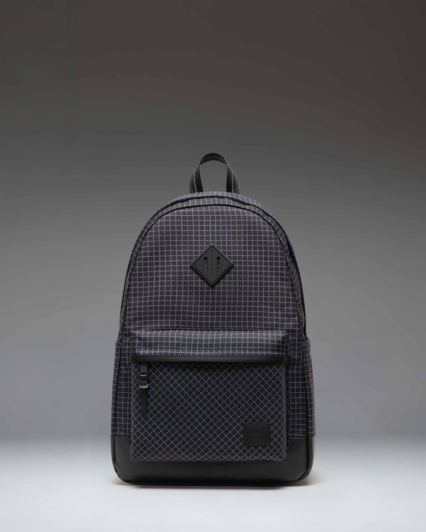 Herschel Heritage Backpack in Grid Black/Black, showing the classic design, front pocket, and signature woven label.
