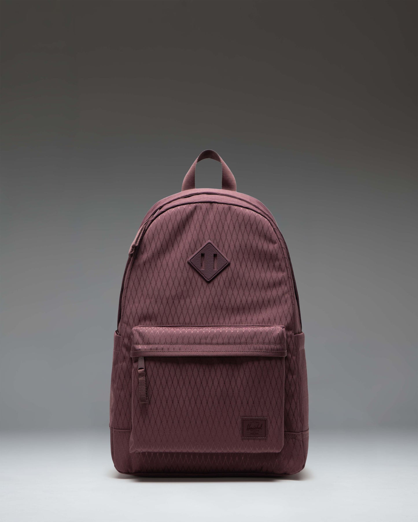Herschel Heritage Backpack in Huckleberry Diamond, featuring a classic dark blue and maroon diamond pattern design.