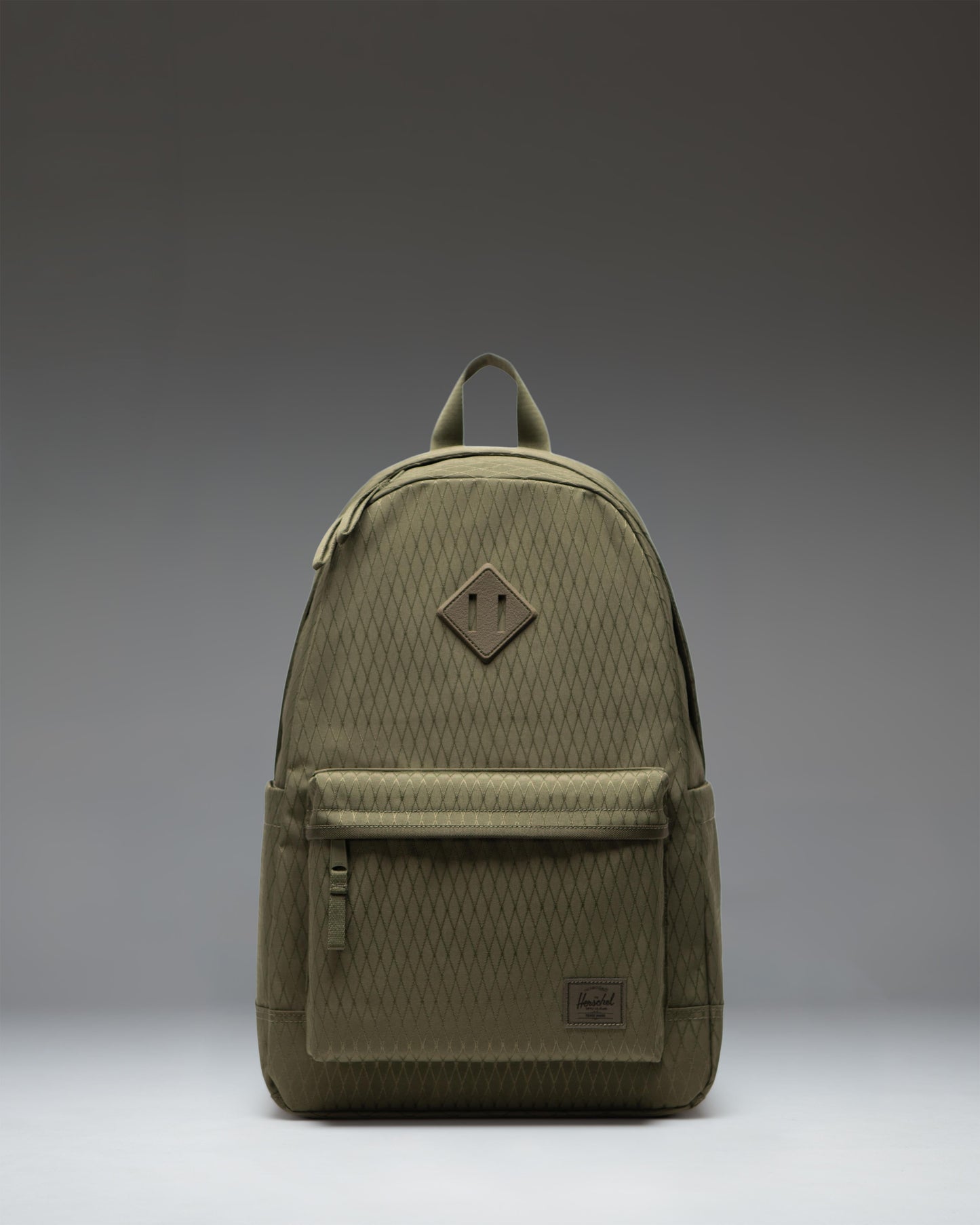 Herschel Supply Co. Herschel Heritage Backpack in Ivy Green Diamond, showcasing the classic design, front pocket, and signature logo label.