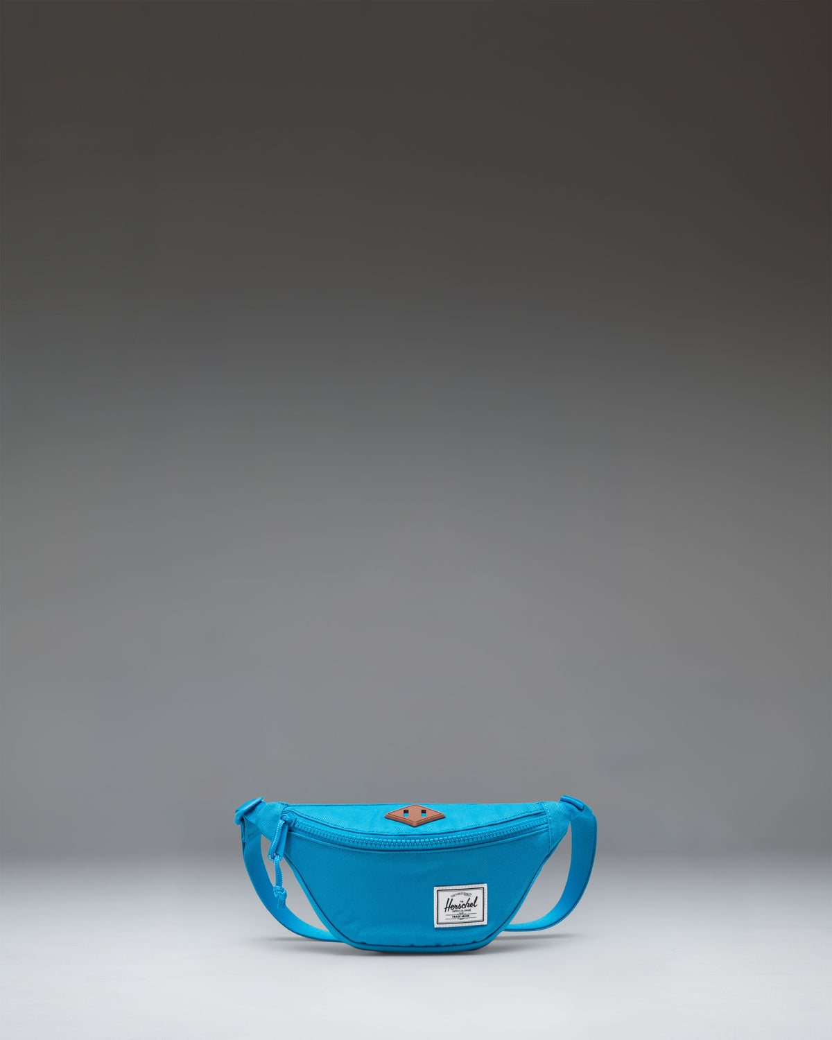 Herschel Heritage Hip Pack Little Herschel in Hawaiian Surf blue, showing the front view with zipper detail.
