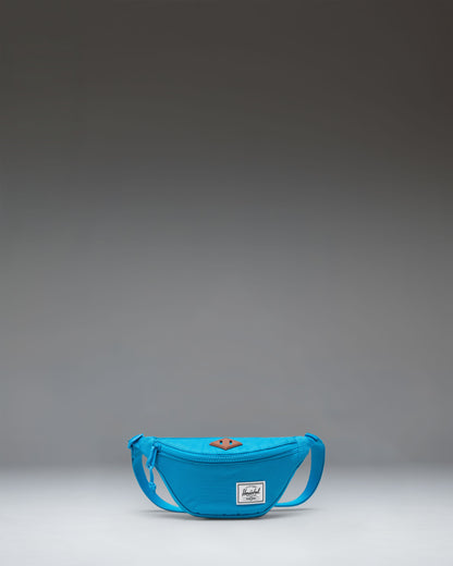 Herschel Heritage Hip Pack Little Herschel in Hawaiian Surf blue, showing the front view with zipper detail.