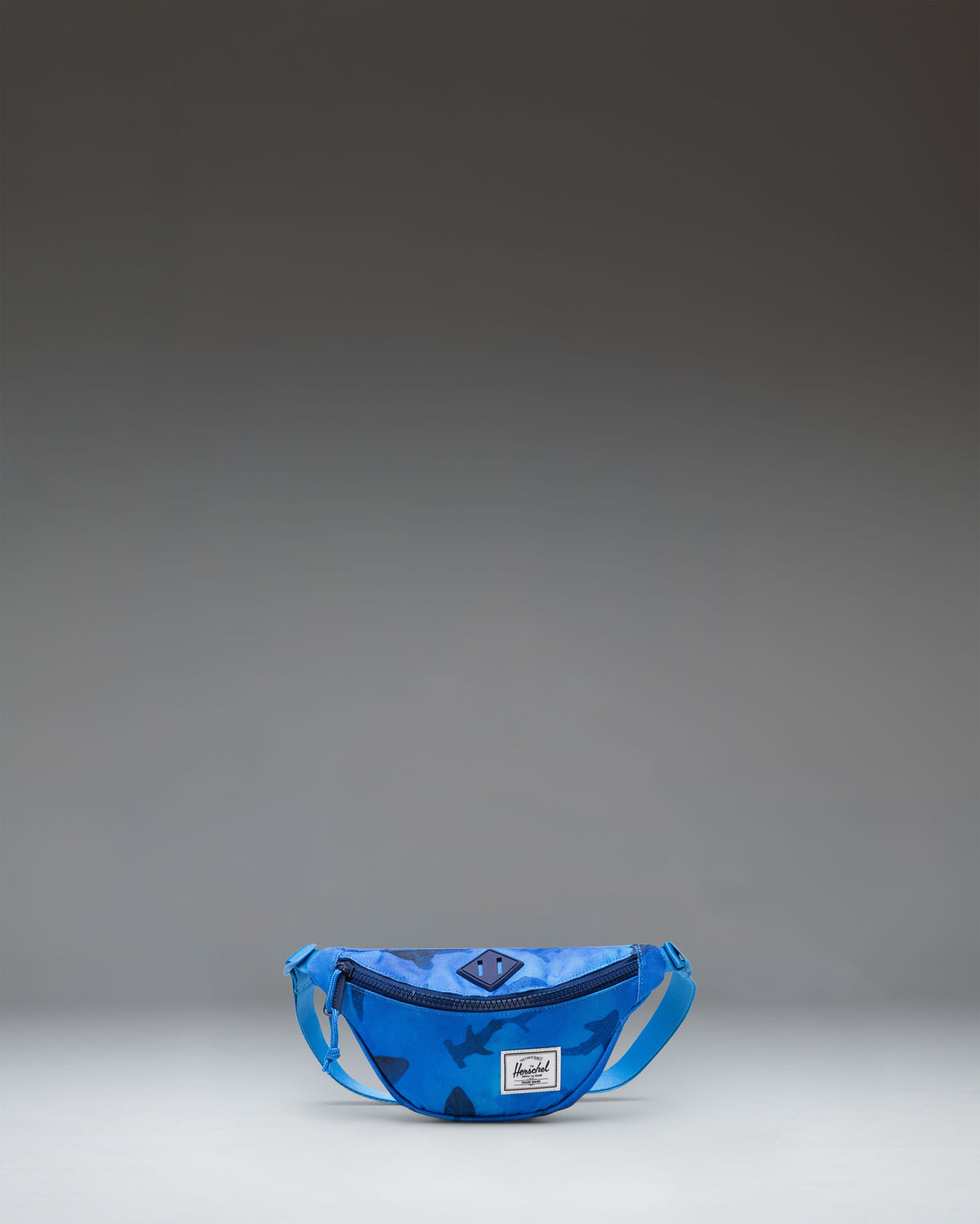 Herschel Heritage Hip Pack Little Herschel in Sharks color, featuring a blue background with shark illustrations.