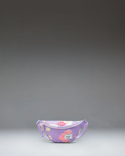 Herschel Heritage Hip Pack Little Herschel in Cakes colorway, featuring a whimsical pattern of birthday cakes, candles, and sprinkles.