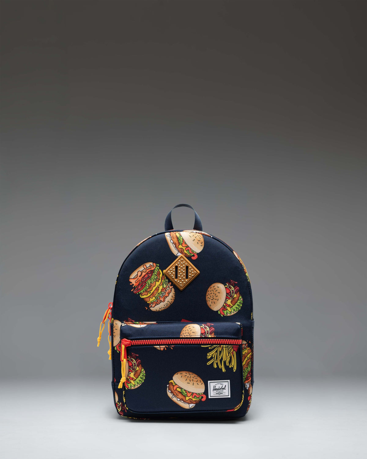 Herschel Heritage Kids Backpack in color 19-3921TCX/17-1558TCX, showing the front design with a zippered pocket and key clip.