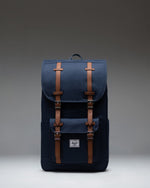 Navy blue Herschel Little America Backpack with classic front pocket and brown fastening straps.