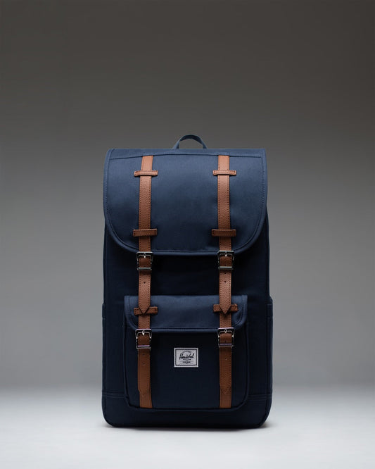 Navy blue Herschel Little America Backpack with classic front pocket and brown fastening straps.