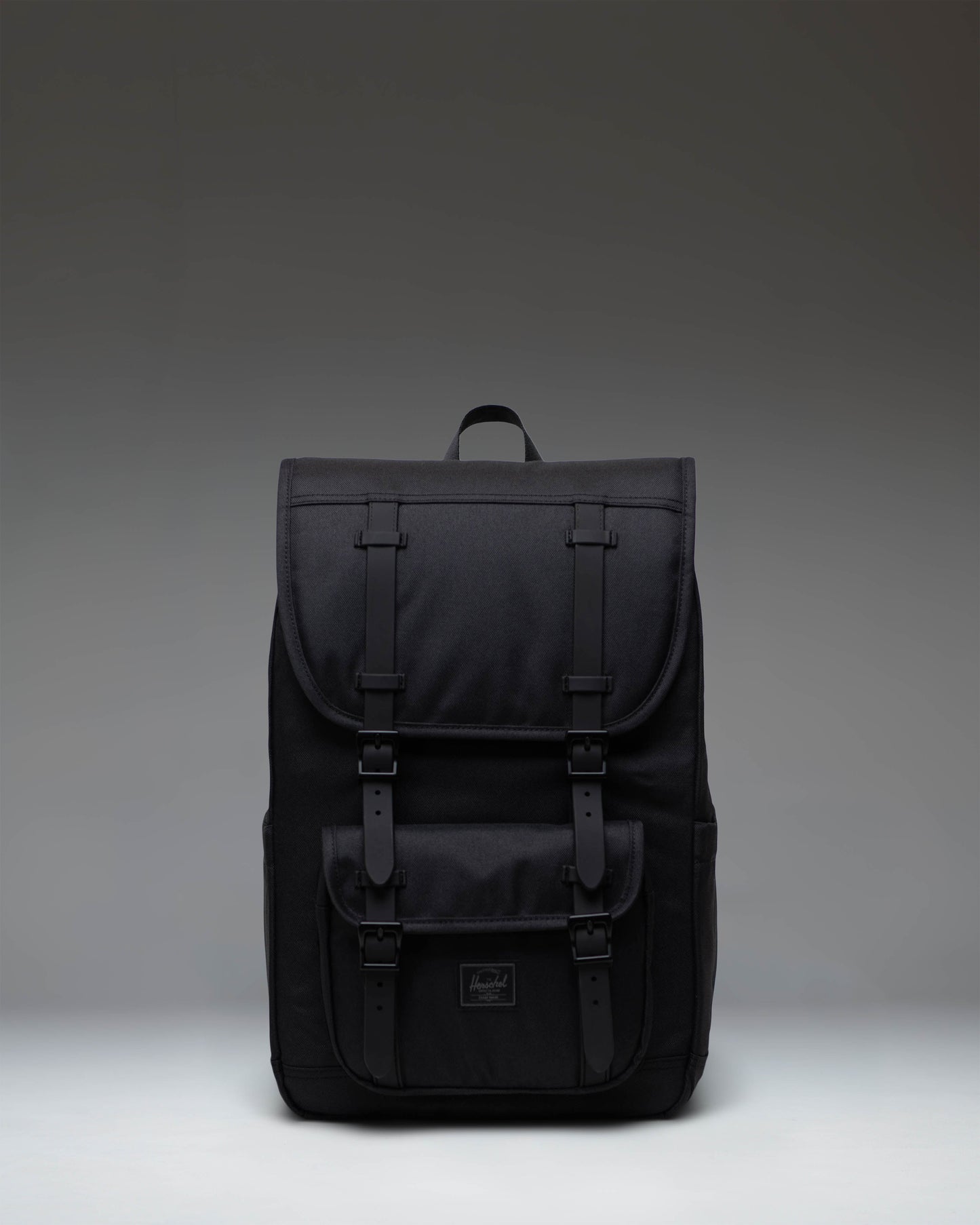 Herschel Little America Mid Backpack in Black Tonal, showing the front view with signature rubber straps and woven label.