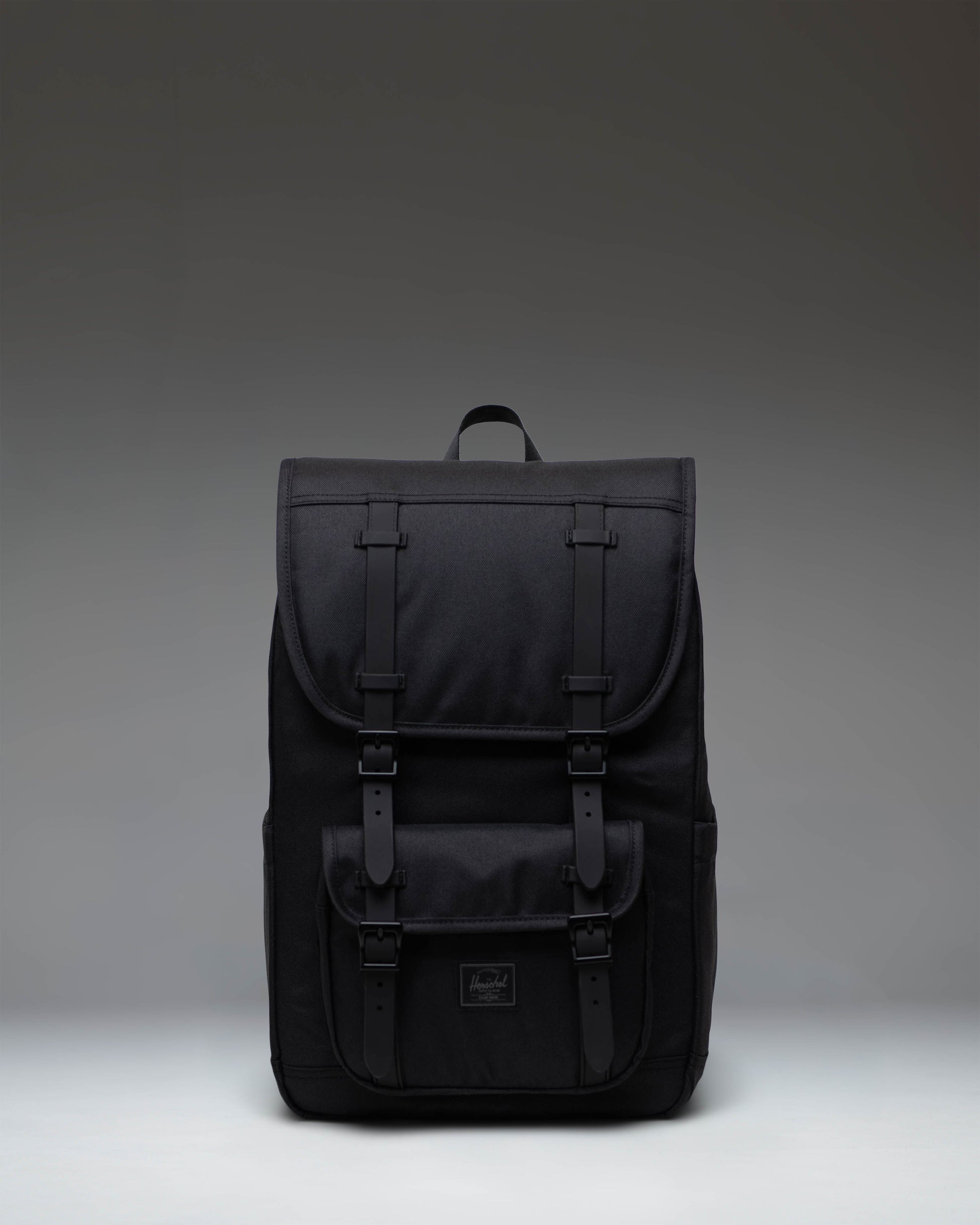 Herschel Little America Mid Backpack in Black Tonal, showing the front view with signature rubber straps and woven label.