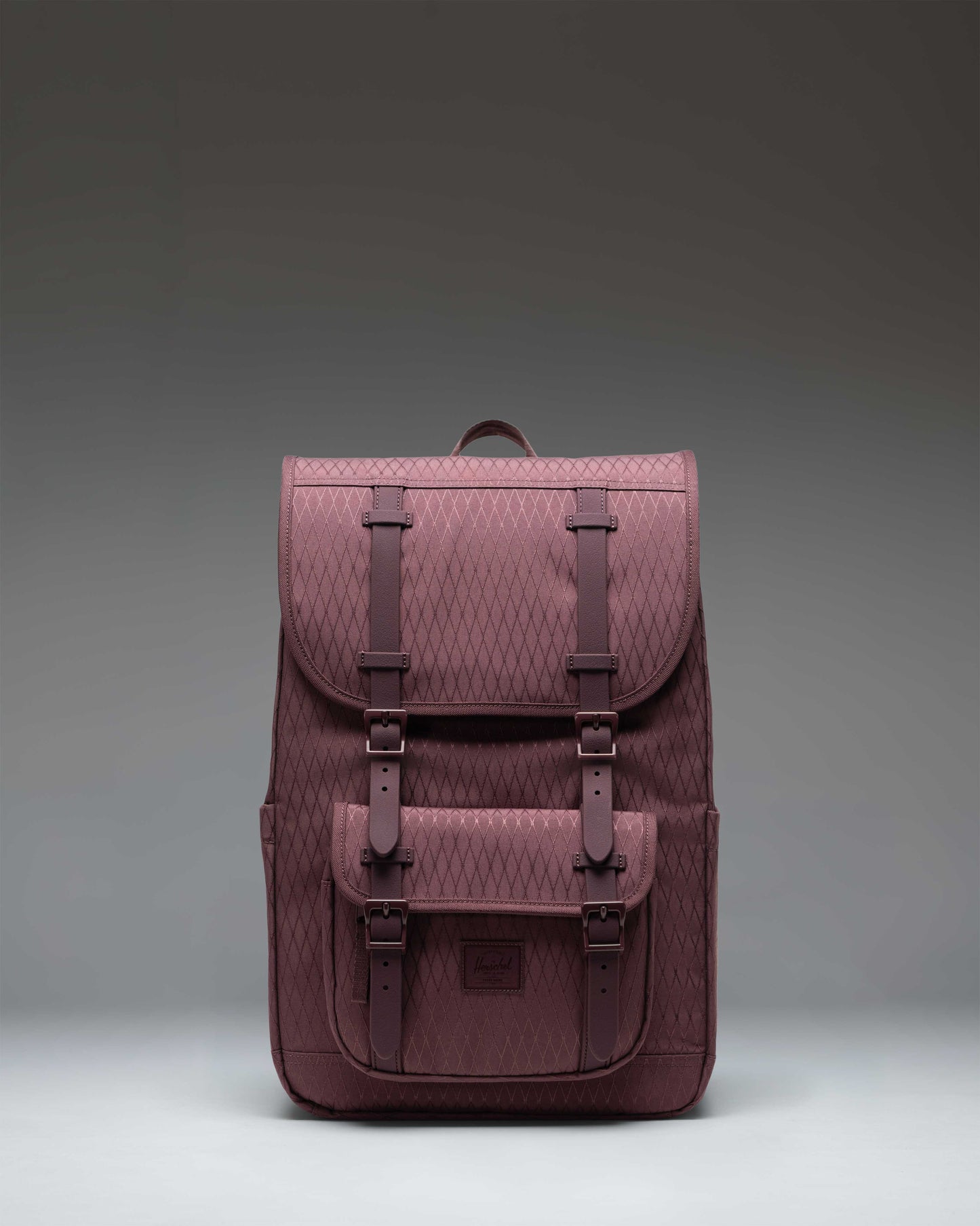 Herschel Little America Mid Backpack in Huckleberry Diamond, featuring a purple geometric pattern, front pocket, and black rubber straps.