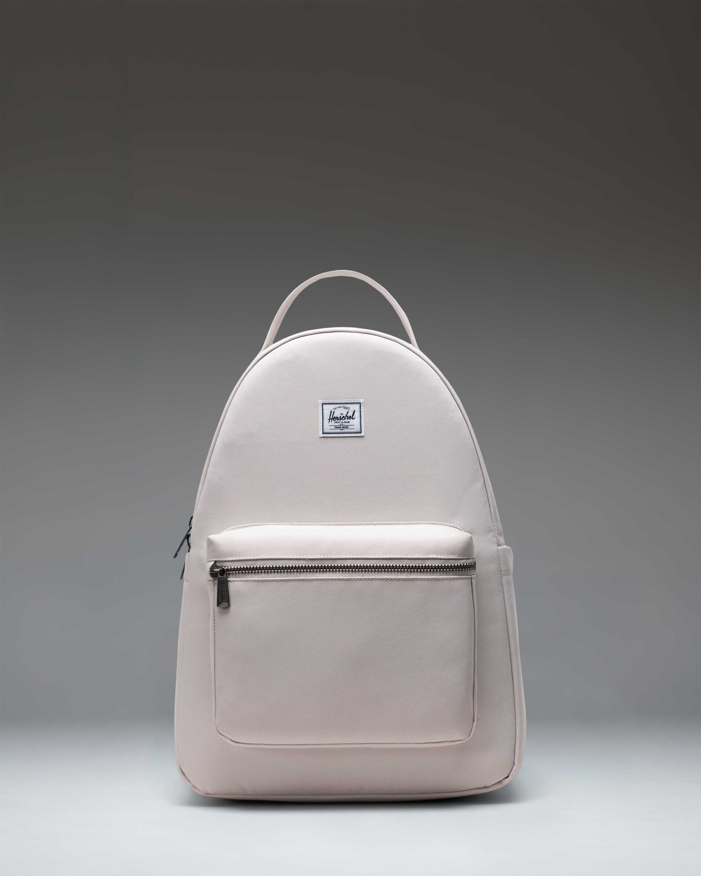 Herschel Nova Backpack in Moonbeam colorway, showcasing a front zipper pocket, slim shoulder straps, and top dual carrying handles.