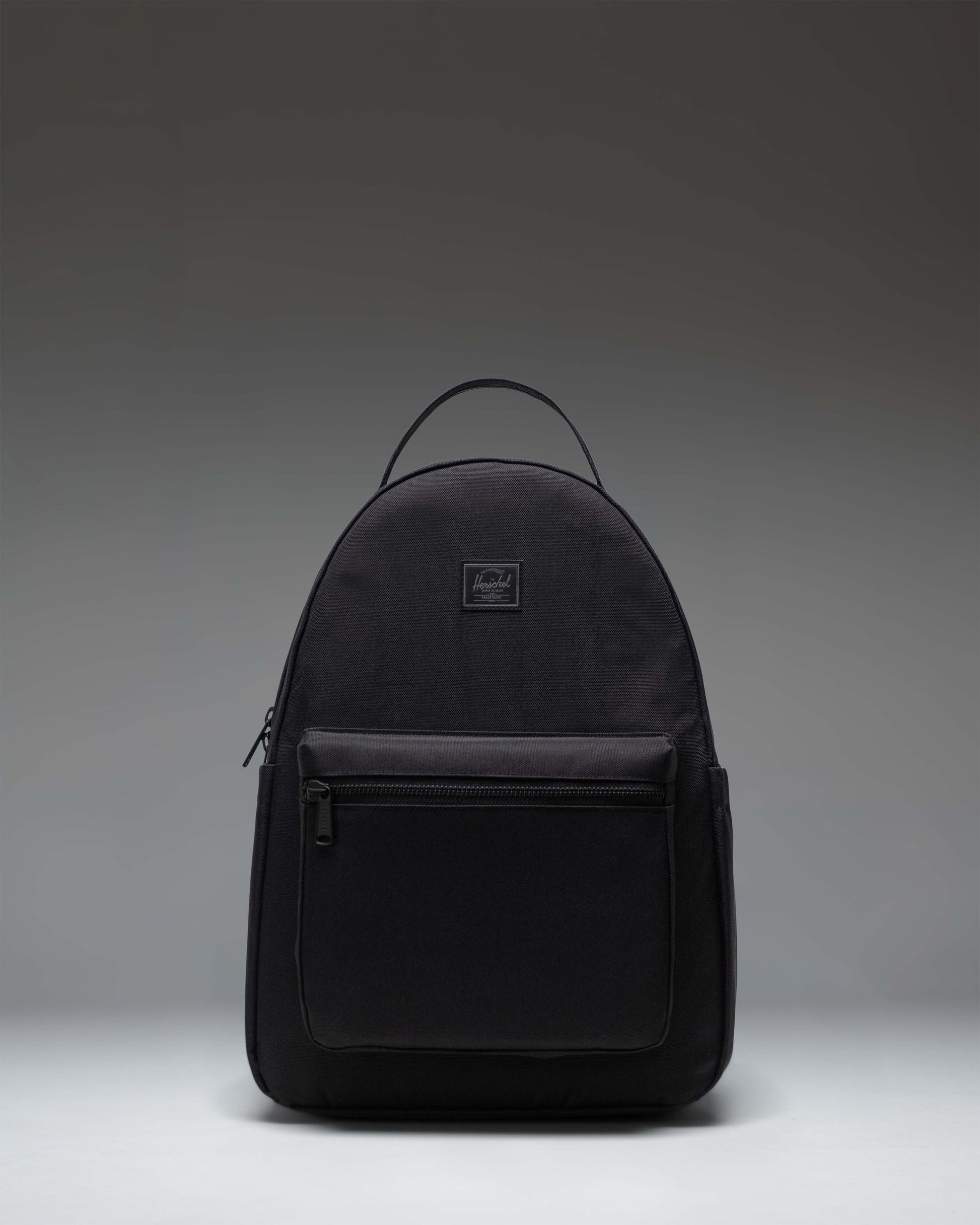 Herschel Nova Backpack in Black Tonal, showing the front view with dual top carrying handles and a front storage pocket.