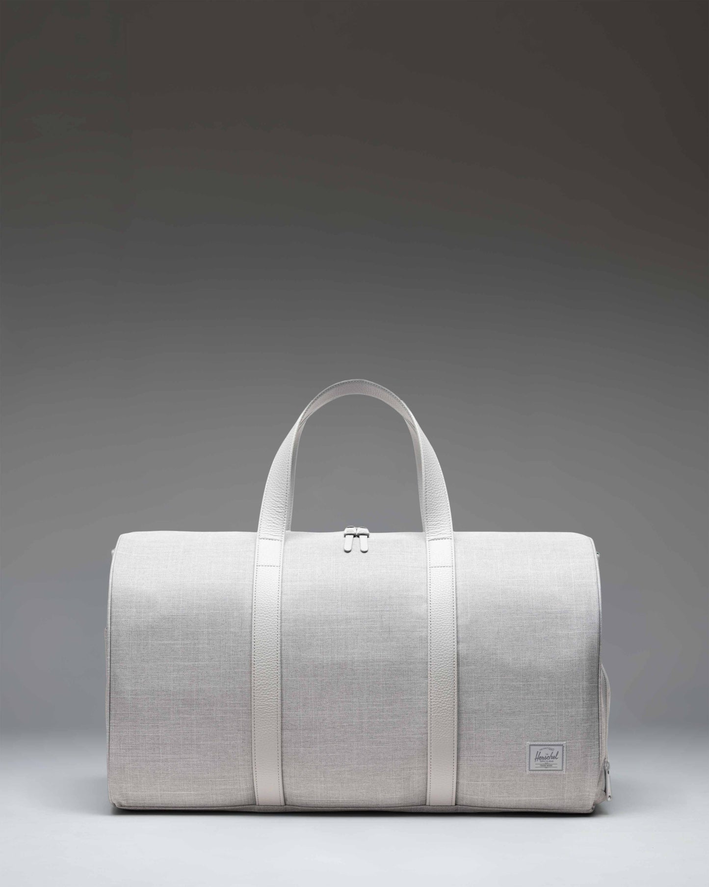Herschel Novel Duffle bag in Grey Crosshatch featuring a classic barrel shape, dual top handles, and a removable shoulder strap.