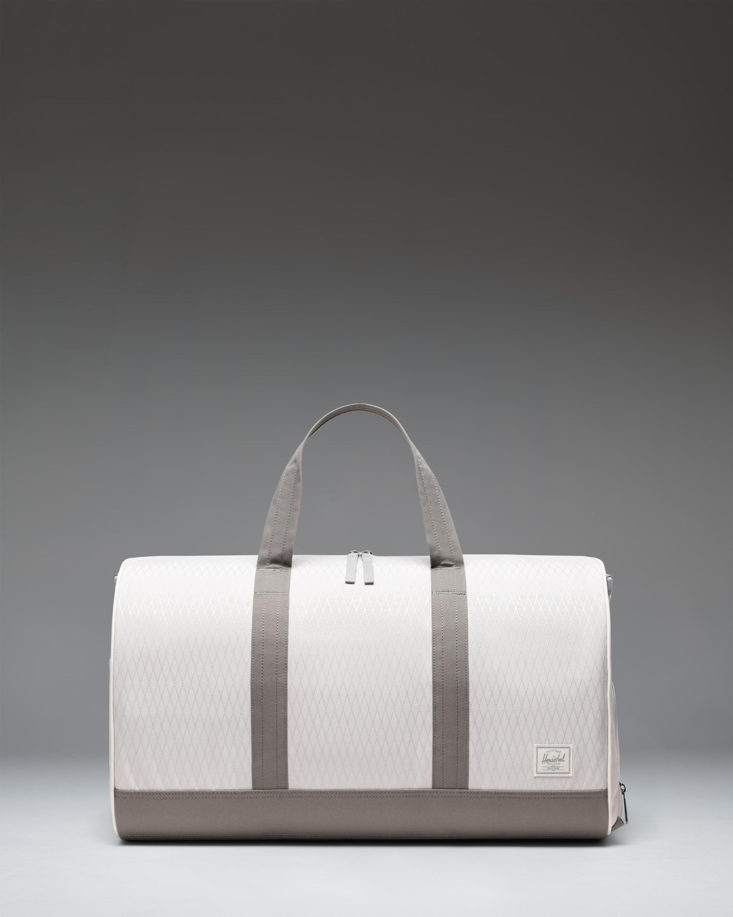 Herschel Novel Duffle bag in Vapor Diamond and Charcoal Gray, showing the side and front view.