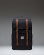 Black Herschel Retreat Backpack featuring a classic cinch top design, dual magnetic strap closures, and a front storage sleeve.