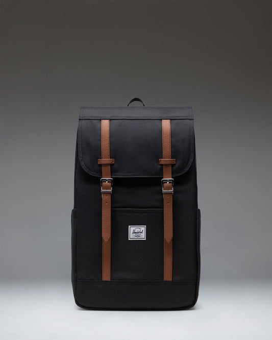 Black Herschel Retreat Backpack featuring a classic cinch top design, dual magnetic strap closures, and a front storage sleeve.